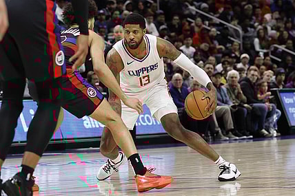Feb 2, 2024; Detroit, Michigan, USA;  LA Clippers forward Paul George (13) dribbles defended by Detroit Pistons guard Cade Cunningham (2) in the first half at Little Caesars Arena. Mandatory Credit: Rick Osentoski-USA TODAY Sports
