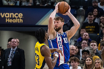 Feb 2, 2024; Indianapolis, Indiana, USA; Sacramento Kings forward Domantas Sabonis (10) holds the ball while  Indiana Pacers forward Aaron Nesmith (23) defends in the first half at Gainbridge Fieldhouse. Mandatory Credit: Trevor Ruszkowski-USA TODAY Sports