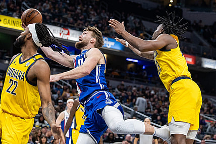 Feb 2, 2024; Indianapolis, Indiana, USA; Sacramento Kings forward Domantas Sabonis (10) shoots the ball while Indiana Pacers forward Isaiah Jackson (22) and forward Aaron Nesmith (23) defend in the second half at Gainbridge Fieldhouse. Mandatory Credit: Trevor Ruszkowski-USA TODAY Sports