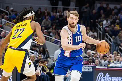 Feb 2, 2024; Indianapolis, Indiana, USA; Sacramento Kings forward Domantas Sabonis (10) dribbles the ball while Indiana Pacers forward Isaiah Jackson (22) defends in the second half at Gainbridge Fieldhouse. Mandatory Credit: Trevor Ruszkowski-USA TODAY Sports