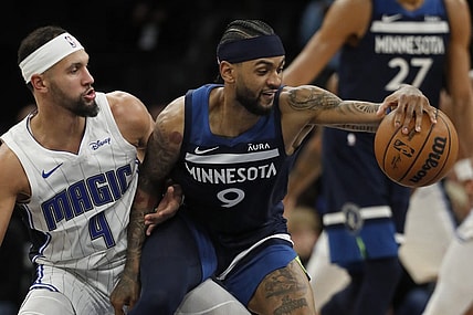 Feb 2, 2024; Minneapolis, Minnesota, USA; Minnesota Timberwolves guard Nickeil Alexander-Walker (9) works around Orlando Magic guard Jalen Suggs (4) in the fourth quarter at Target Center. Mandatory Credit: Bruce Kluckhohn-USA TODAY Sports