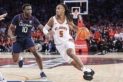 Feb 3, 2024; New York, New York, USA;  St. John's Red Storm guard Daniss Jenkins (5) drives past Connecticut Huskies guard Hassan Diarra (10) in the second half at Madison Square Garden. Mandatory Credit: Wendell Cruz-USA TODAY Sports