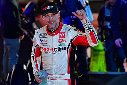 Feb 3, 2024; Los Angeles, California, USA;  NASCAR Cup Series driver Denny Hamlin (11) celebrates his victory of the Busch Light Clash at Los Angeles Memorial Coliseum. Mandatory Credit: Gary A. Vasquez-USA TODAY Sports