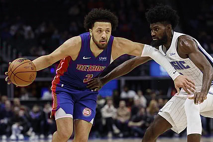 Feb 4, 2024; Detroit, Michigan, USA; Detroit Pistons guard Cade Cunningham (2) dribbles defended by Orlando Magic forward Jonathan Isaac (1) in the second half at Little Caesars Arena. Mandatory Credit: Rick Osentoski-USA TODAY Sports