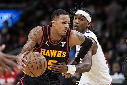 Feb 5, 2024; Atlanta, Georgia, USA; Atlanta Hawks guard Dejounte Murray (5) dribbles past LA Clippers guard Terance Mann (14) during the first half at State Farm Arena. Mandatory Credit: Dale Zanine-USA TODAY Sports
