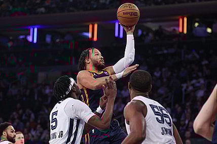 Feb 6, 2024; New York, New York, USA; New York Knicks guard Jalen Brunson (11) drives to the basket against Memphis Grizzlies forward Vince Williams Jr. and center Trey Jemison (55) during the first quarter at Madison Square Garden. Mandatory Credit: Vincent Carchietta-USA TODAY Sports