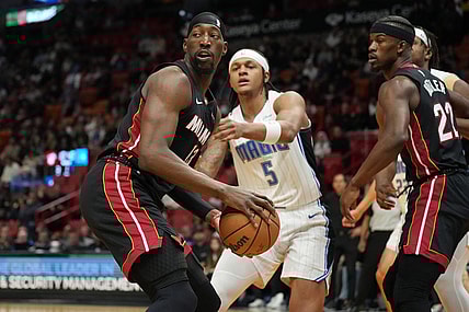 Feb 6, 2024; Miami, Florida, USA;  Miami Heat center Bam Adebayo (13) looks to pass the ball as Orlando Magic forward Paolo Banchero (5) defends during the first half at Kaseya Center. Mandatory Credit: Jim Rassol-USA TODAY Sports