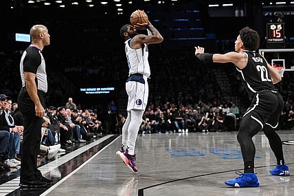 Feb 6, 2024; Brooklyn, New York, USA; Dallas Mavericks guard Kyrie Irving (11) shoots as Brooklyn Nets forward Jalen Wilson (22) defends during the second quarter at Barclays Center. Mandatory Credit: John Jones-USA TODAY Sports