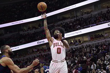 Feb 6, 2024; Chicago, Illinois, USA; Chicago Bulls guard Coby White (0) shoots over Minnesota Timberwolves center Rudy Gobert (27) during the first quarter at United Center. Mandatory Credit: David Banks-USA TODAY Sports
