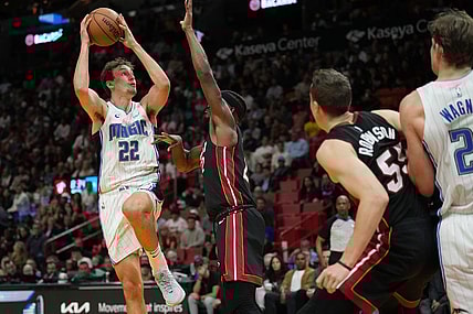Feb 6, 2024; Miami, Florida, USA;  Orlando Magic forward Franz Wagner (22) goes up for a shot over Miami Heat forward Jimmy Butler (22) during the second half at Kaseya Center. Mandatory Credit: Jim Rassol-USA TODAY Sports