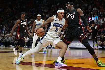Feb 6, 2024; Miami, Florida, USA;  Orlando Magic forward Paolo Banchero (5) drives to the basket as Miami Heat center Bam Adebayo (13) defends during the second half at Kaseya Center. Mandatory Credit: Jim Rassol-USA TODAY Sports