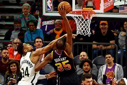 Feb 6, 2024; Phoenix, Arizona, USA; Phoenix Suns forward Kevin Durant (35) shoots the ball against Milwaukee Bucks forward Giannis Antetokounmpo (34) during the fourth quarter at Footprint Center. Mandatory Credit: Mark J. Rebilas-USA TODAY Sports