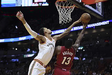 Feb 7, 2024; Miami, Florida, USA; San Antonio Spurs center Victor Wembanyama (1) blocks a shot against Miami Heat center Bam Adebayo (13) during the first quarter at Kaseya Center. Mandatory Credit: Sam Navarro-USA TODAY Sports