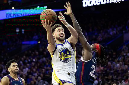 Feb 7, 2024; Philadelphia, Pennsylvania, USA; Golden State Warriors guard Klay Thompson (11) scores past Philadelphia 76ers guard Patrick Beverley (22) during the third quarter at Wells Fargo Center. Mandatory Credit: Bill Streicher-USA TODAY Sports