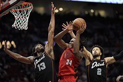 Feb 8, 2024; Portland, Oregon, USA; Portland Trail Blazers forward Jabari Walker (34) shoots the ball against Detroit Pistons center James Wiseman (13) and point guard Cade Cunningham (2) during the second half at Moda Center. Mandatory Credit: Soobum Im-USA TODAY Sports