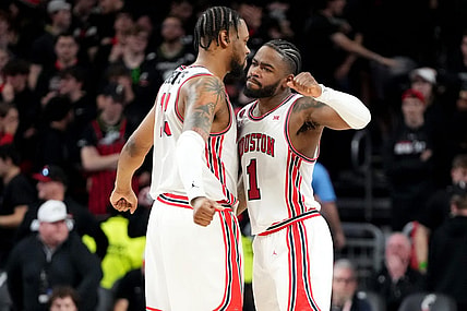 Houston Cougars forward J'Wan Roberts (13) and Houston Cougars guard Jamal Shead (1) celebrate the win at the conclusion of the second half of an NCAA college basketball game against the Cincinnati Bearcats, Saturday, Feb. 10, 2024, at Fifth Third Arena in Cincinnati.