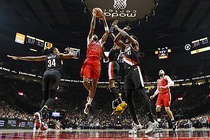 Feb 10, 2024; Portland, Oregon, USA; New Orleans Pelicans small forward Brandon Ingram (14) drives for the basket between Portland Trail Blazers forward Jabari Walker (34) and small forward Jerami Grant (9, right) during the first half at Moda Center. Mandatory Credit: Soobum Im-USA TODAY Sports