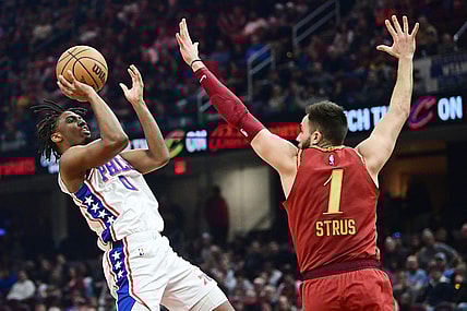 Feb 12, 2024; Cleveland, Ohio, USA; Philadelphia 76ers guard Tyrese Maxey (0) shoots over the defense of  Cleveland Cavaliers guard Max Strus (1) during the first half at Rocket Mortgage FieldHouse. Mandatory Credit: Ken Blaze-USA TODAY Sports