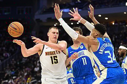 Feb 12, 2024; Milwaukee, Wisconsin, USA; Denver Nuggets center Nikola Jokic (15) passes against Milwaukee Bucks forward Giannis Antetokounmpo (34) in the third quarter at Fiserv Forum. Mandatory Credit: Benny Sieu-USA TODAY Sports