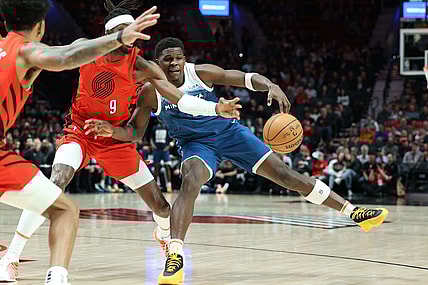 Feb 13, 2024; Portland, Oregon, USA; Minnesota Timberwolves guard Anthony Edwards (5) fights for possession against Portland Trail Blazers forward Jerami Grant (9) in the first quarter at Moda Center. Mandatory Credit: Jaime Valdez-USA TODAY Sports