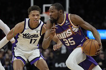 Feb 13, 2024; Phoenix, Arizona, USA; Phoenix Suns forward Kevin Durant (35) drives on Sacramento Kings forward Kessler Edwards (17)  in the first half at Footprint Center. Mandatory Credit: Rick Scuteri-USA TODAY Sports
