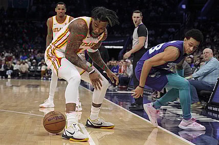 Feb 14, 2024; Charlotte, North Carolina, USA; Atlanta Hawks forward Saddiq Bey (41) loses the ball defended by Charlotte Hornets guard Tre Mann (23) during the second quarter at Spectrum Center. Mandatory Credit: Jim Dedmon-USA TODAY Sports