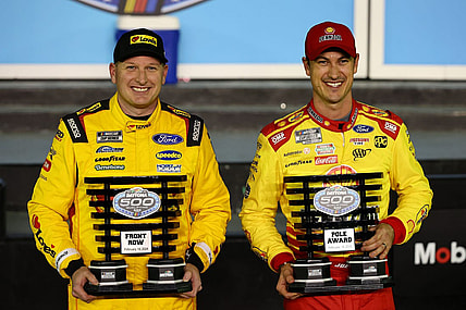 Feb 14, 2024; Daytona Beach, Florida, USA; NASCAR Cup Series driver Joey Logano (right) poses with the pole award with driver Michael McDowell (left), qualified second, after qualifying for the Daytona 500 at Daytona International Speedway. Mandatory Credit: Mark J. Rebilas-USA TODAY Sports