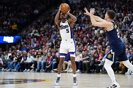 Feb 14, 2024; Denver, Colorado, USA; Sacramento Kings guard De'Aaron Fox (5) shoots the ball over Denver Nuggets guard Collin Gillespie (21) in the second half at Ball Arena. Mandatory Credit: Ron Chenoy-USA TODAY Sports