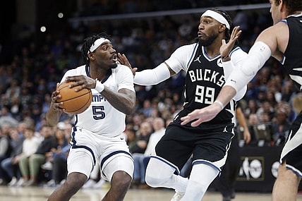 Feb 15, 2024; Memphis, Tennessee, USA; Memphis Grizzlies guard Vince Williams Jr. (5) handles the ball as Milwaukee Bucks forward Jae Crowder (99) defends during the first half at FedExForum. Mandatory Credit: Petre Thomas-USA TODAY Sports
