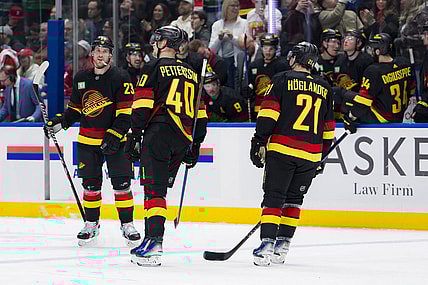 Feb 15, 2024; Vancouver, British Columbia, CAN; Vancouver Canucks forward Nils Hoglander (21) and forward Elias Pettersson (40) and celebrate Lindholm s second goal of the game against the Detroit Red Wings in the third period at Rogers Arena. Vancouver won 4-1. Mandatory Credit: Bob Frid-USA TODAY Sports