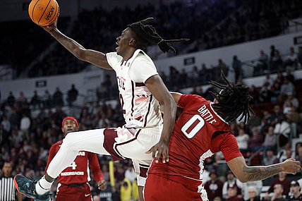 Feb 17, 2024; Starkville, Mississippi, USA; Mississippi State Bulldogs forward KeShawn Murphy (12) collects a rebound over Arkansas Razorbacks guard Khalif Battle (0) during the first half at Humphrey Coliseum. Mandatory Credit: Petre Thomas-USA TODAY Sports