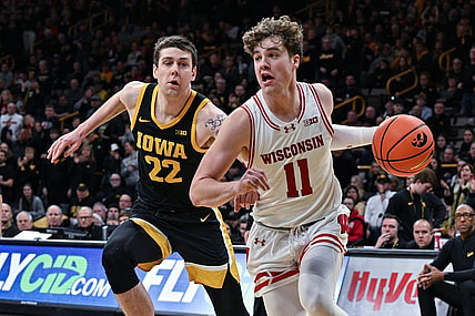 Feb 17, 2024; Iowa City, Iowa, USA; Wisconsin Badgers guard Max Klesmit (11) goes to the basket as Iowa Hawkeyes forward Patrick McCaffery (22) defends during the first half at Carver-Hawkeye Arena. Mandatory Credit: Jeffrey Becker-USA TODAY Sports