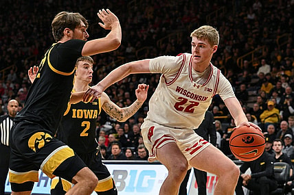 Feb 17, 2024; Iowa City, Iowa, USA; Wisconsin Badgers forward Steven Crowl (22) controls the ball as Iowa Hawkeyes forward Owen Freeman (32) and guard Brock Harding (2) defend during the first half at Carver-Hawkeye Arena. Mandatory Credit: Jeffrey Becker-USA TODAY Sports