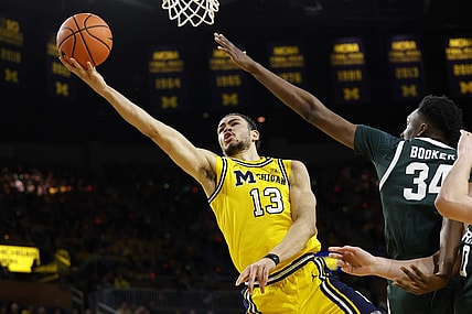 Feb 17, 2024; Ann Arbor, Michigan, USA; Michigan Wolverines forward Olivier Nkamhoua (13) shoots on Michigan State Spartans forward Xavier Booker (34) in the first half  at Crisler Center. Mandatory Credit: Rick Osentoski-USA TODAY Sports