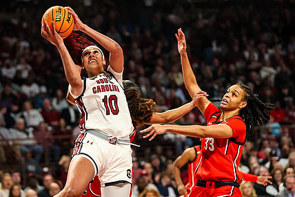 Feb 18, 2024; Columbia, South Carolina, USA; South Carolina Gamecocks center Kamilla Cardoso (10) shoots over Georgia Lady Bulldogs forward Destiny Thomas (33) in the first half at Colonial Life Arena. Mandatory Credit: Jeff Blake-USA TODAY Sports