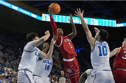 Feb 18, 2024; Los Angeles, California, USA; Utah Utes guard Deivon Smith (5) shoots the ball against forward Kenneth Nwuba (14) and guard Lazar Stefanovic (10) in the first half at Pauley Pavilion presented by Wescom. Mandatory Credit: Kirby Lee-USA TODAY Sports