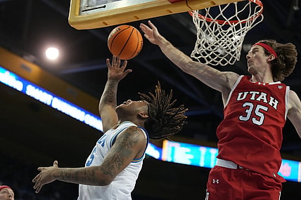 Feb 18, 2024; Los Angeles, California, USA; UCLA Bruins guard Brandon Williams (5) shoots the ball against Utah Utes center Branden Carlson (35) in the second half at Pauley Pavilion presented by Wescom. Utah defeated UCLA 70-69. Mandatory Credit: Kirby Lee-USA TODAY Sports