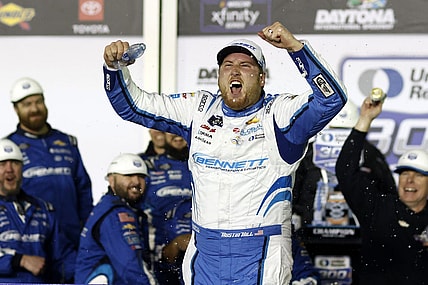 Feb 19, 2024; Daytona Beach, Florida, USA;  Xfinity Series driver Austin Hill (21) reacts in victory lane after winning the United Rentals 300 at Daytona International Speedway. Mandatory Credit: Peter Casey-USA TODAY Sports