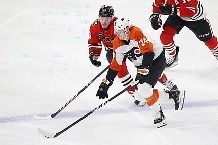 Feb 21, 2024; Chicago, Illinois, USA; Chicago Blackhawks right wing Joey Anderson (15) defends against Philadelphia Flyers right wing Owen Tippett (74) during the second period at United Center. Mandatory Credit: Kamil Krzaczynski-USA TODAY Sports