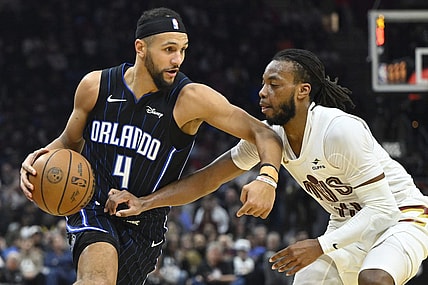 Feb 22, 2024; Cleveland, Ohio, USA; Orlando Magic guard Jalen Suggs (4) dribbles beside Cleveland Cavaliers guard Darius Garland (10) in the second quarter at Rocket Mortgage FieldHouse. Mandatory Credit: David Richard-USA TODAY Sports
