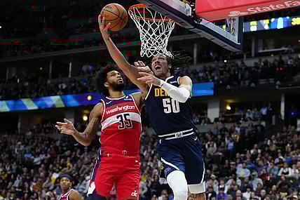 Feb 22, 2024; Denver, Colorado, USA; Denver Nuggets forward Aaron Gordon (50) shoots past Washington Wizards forward Marvin Bagley III (35) in the second quarter at Ball Arena. Mandatory Credit: Ron Chenoy-USA TODAY Sports