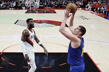 Feb 23, 2024; Portland, Oregon, USA; Denver Nuggets center Nikola Jokic (15) shoots the ball as Portland Trail Blazers center Deandre Anton (2) looks on during the first half at Moda Center. Mandatory Credit: Soobum Im-USA TODAY Sports