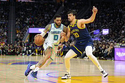 Feb 23, 2024; San Francisco, California, USA; Charlotte Hornets forward Miles Bridges (0) dribbles against Golden State Warriors forward Dario Saric (20) during the fourth quarter at Chase Center. Mandatory Credit: Darren Yamashita-USA TODAY Sports