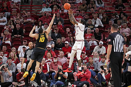 Feb 24, 2024; Fayetteville, Arkansas, USA; Arkansas Razorbacks guard Khalif Battle (0) shoots during the first half as Missouri Tigers guard Nick Honor (10) defends at Bud Walton Arena. Mandatory Credit: Nelson Chenault-USA TODAY Sports