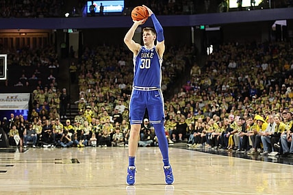 Feb 24, 2024; Winston-Salem, North Carolina, USA;  Duke Blue Devils center Kyle Filipowski (30) makes a three point shot during the second half against the Wake Forest Demon Deacons at Lawrence Joel Veterans Memorial Coliseum. Mandatory Credit: Cory Knowlton-USA TODAY Sports