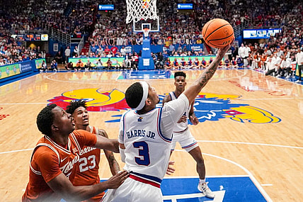 Feb 24, 2024; Lawrence, Kansas, USA; Kansas Jayhawks guard Dajuan Harris Jr. (3) shoots under the basket as Texas Longhorns forward Dillon Mitchell (23) looks on during the second half at Allen Fieldhouse. Mandatory Credit: Denny Medley-USA TODAY Sports