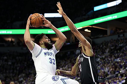Feb 24, 2024; Minneapolis, Minnesota, USA; Minnesota Timberwolves center Karl-Anthony Towns (32) shoots as Brooklyn Nets center Nic Claxton (33) defends during the first half at Target Center. Mandatory Credit: Matt Krohn-USA TODAY Sports