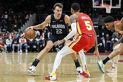 Feb 25, 2024; Atlanta, Georgia, USA; Orlando Magic forward Franz Wagner (22) dribbles against Atlanta Hawks guard Dejounte Murray (5) during the first half at State Farm Arena. Mandatory Credit: Dale Zanine-USA TODAY Sports
