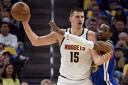 Feb 25, 2024; San Francisco, California, USA; Golden State Warriors forward Jonathan Kuminga (right) harasses Denver Nuggets center Nikola Jokic (15) during the first quarter at Chase Center. Mandatory Credit: D. Ross Cameron-USA TODAY Sports