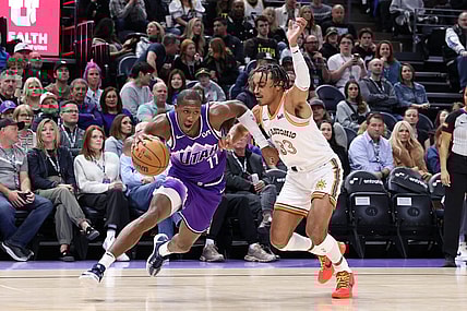 Feb 25, 2024; Salt Lake City, Utah, USA; Utah Jazz guard Kris Dunn (11) drives against San Antonio Spurs guard Tre Jones (33) during the second quarter at Delta Center. Mandatory Credit: Rob Gray-USA TODAY Sports